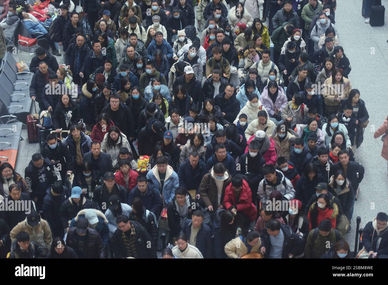 Travelers wait for their trains at a railway station in Hangzhou in