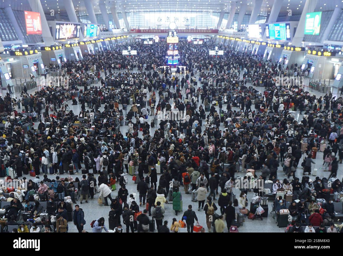 Travelers wait for their trains at a railway station in Hangzhou in