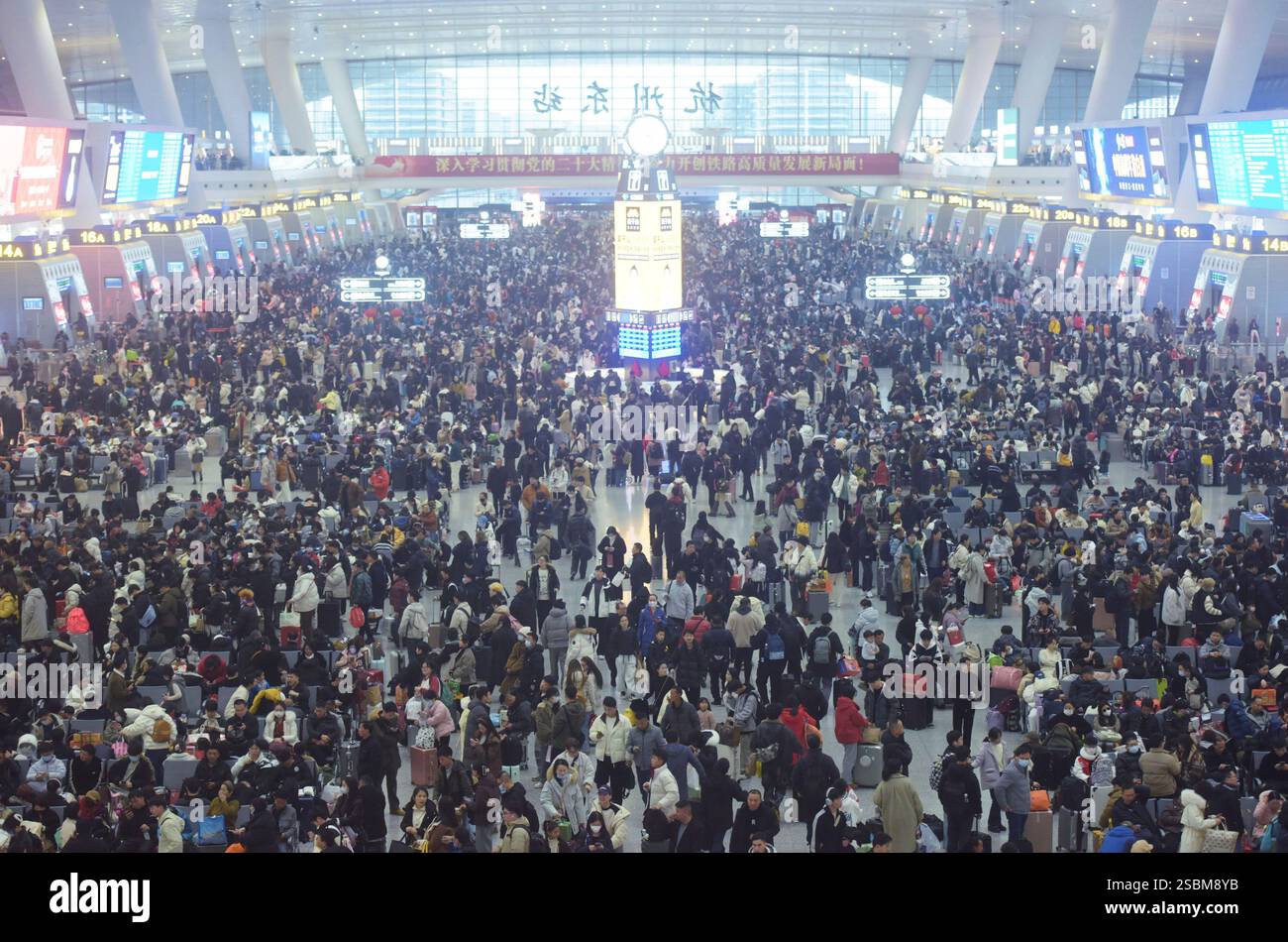 Travelers wait for their trains at a railway station in Hangzhou in