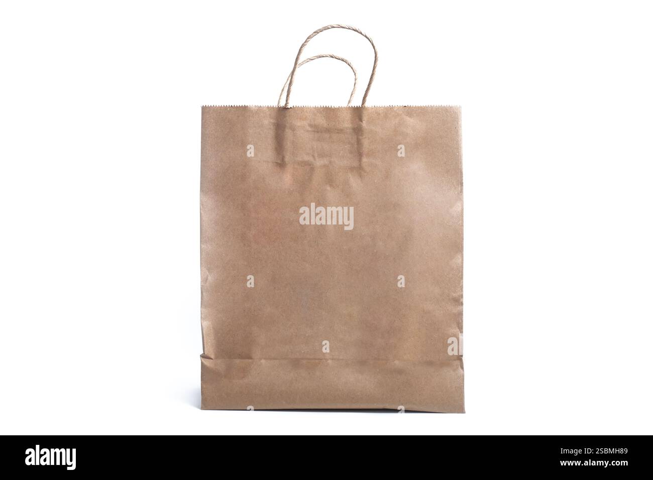 An eco-friendly brown paper bag with sturdy handles that showcases a sustainable alternative for shopping and packaging needs. Stock Photo