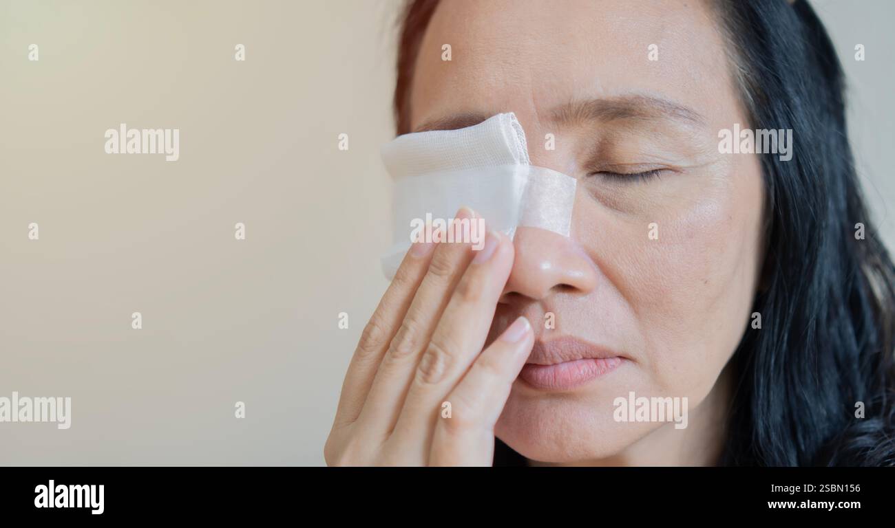 Close up of an adult Asain woman having a gauze bandage on his right