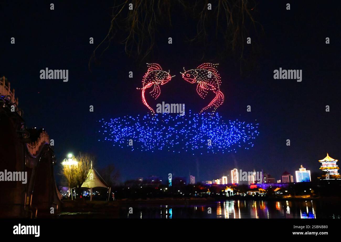 Tourists watch a Chinese Lunar New Year drone light show near Dongchang