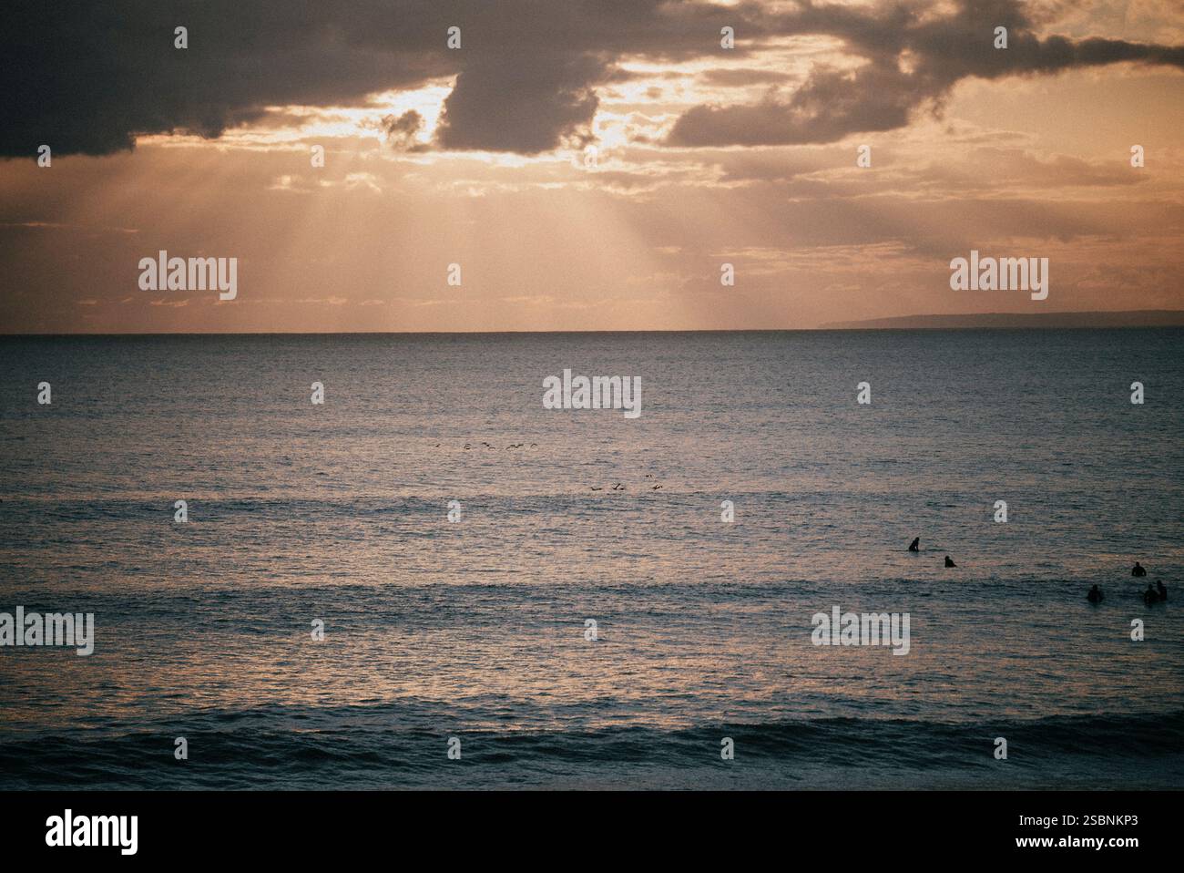 The sun is shining on the ocean, creating a beautiful and peaceful ...