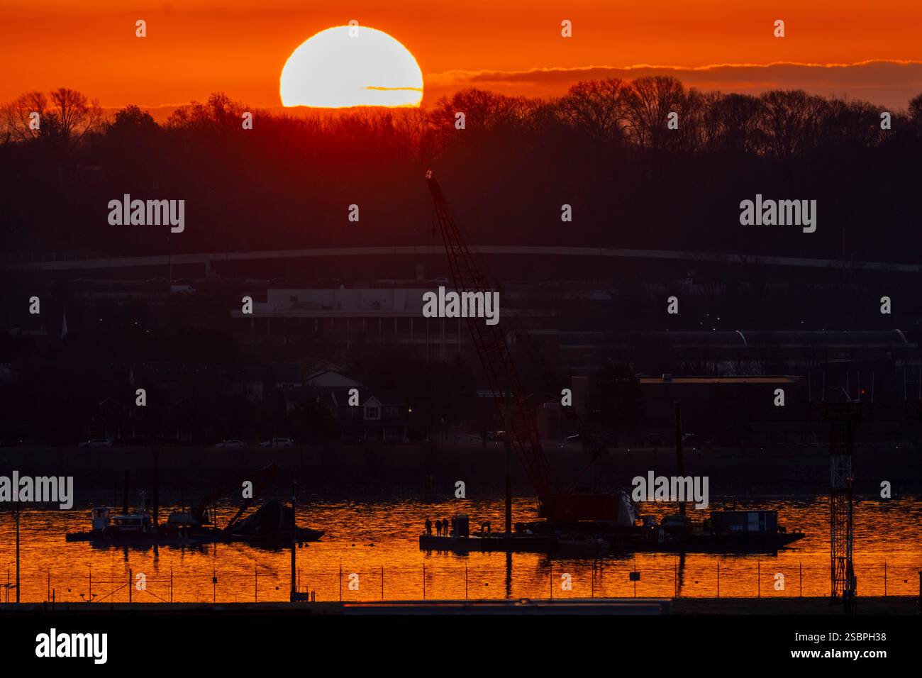 Salvage crews work near the wreckage site in the Potomac River of a mid ...