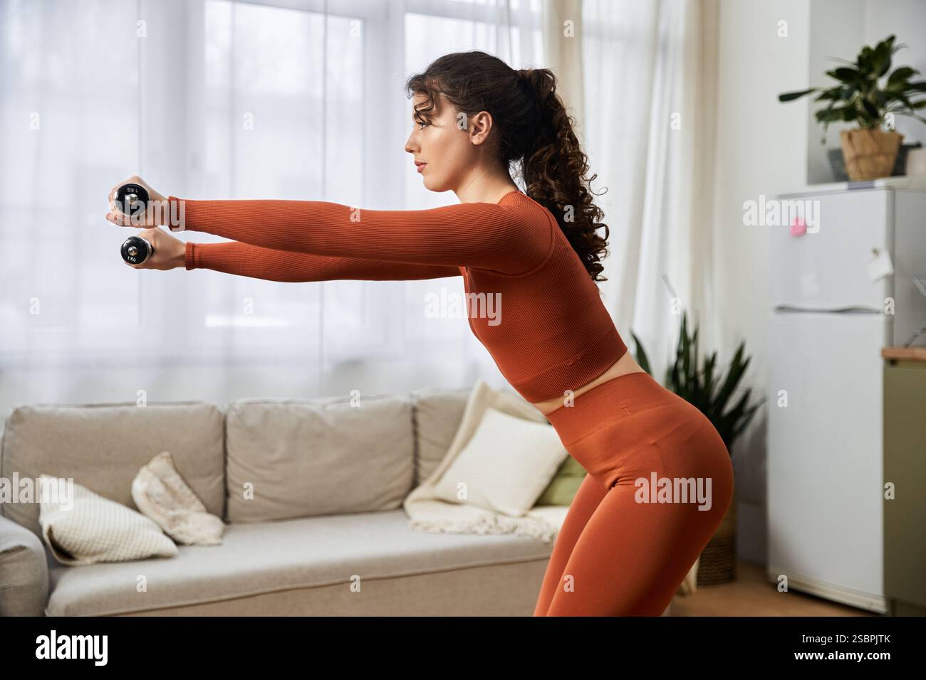 Focused and dedicated, a beautiful young woman engages in a fitness ...