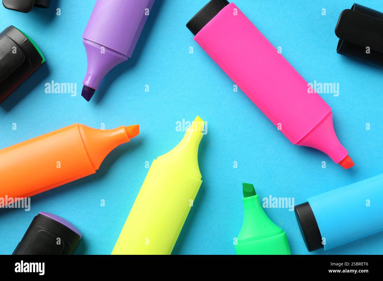 Bright highlighters on light blue background, flat lay Stock Photo