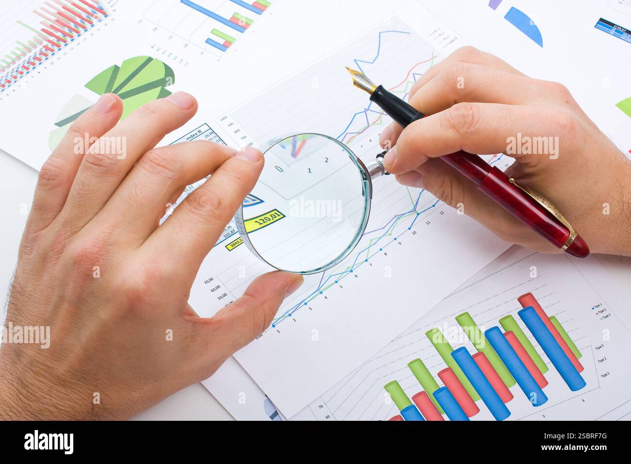 Graphs tables and documents laid on the table Stock Photo