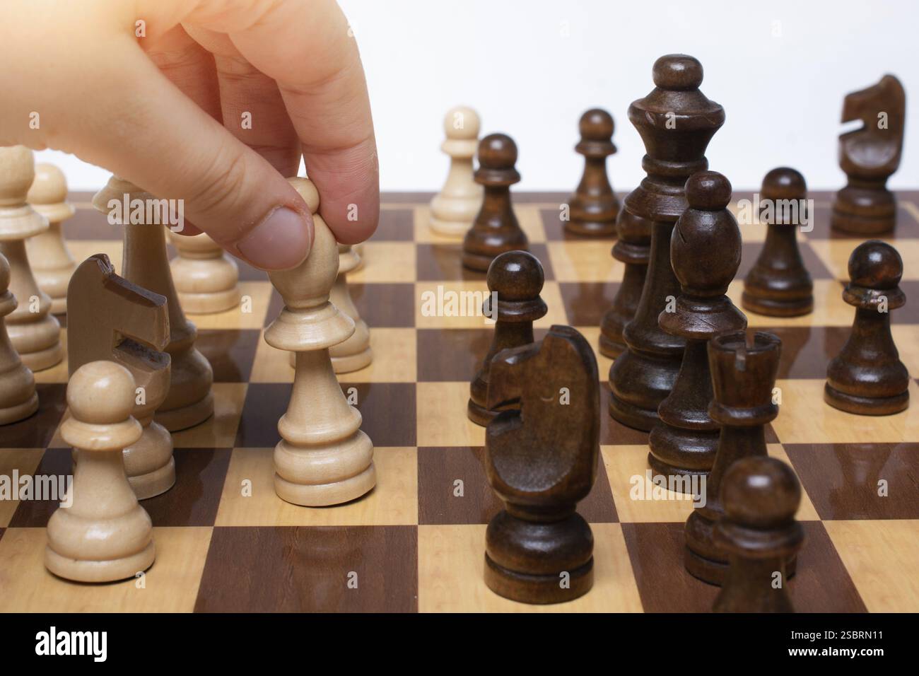 Making A Move Chess Hand making move on chessboard as strategy and leadership concept Stock ...
