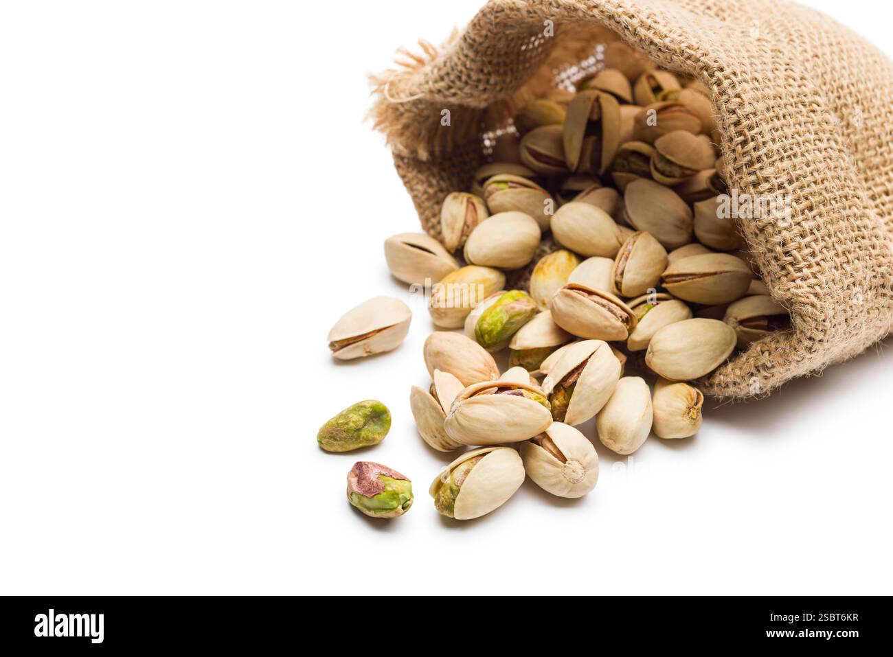 Sack with pistachio nuts, isolated on white background. Stock Photo