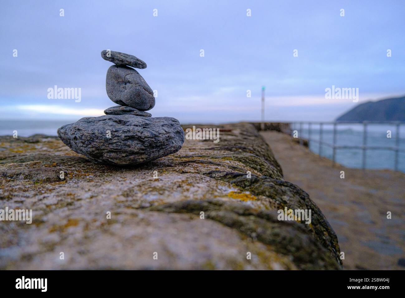 rocks balanced on wall Stock Photo
