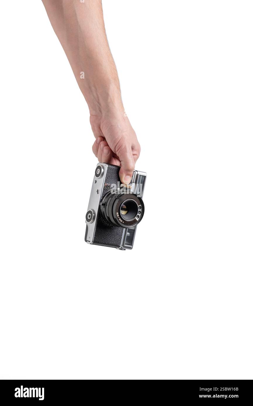 Old camera in hand isolated on white background Stock Photo