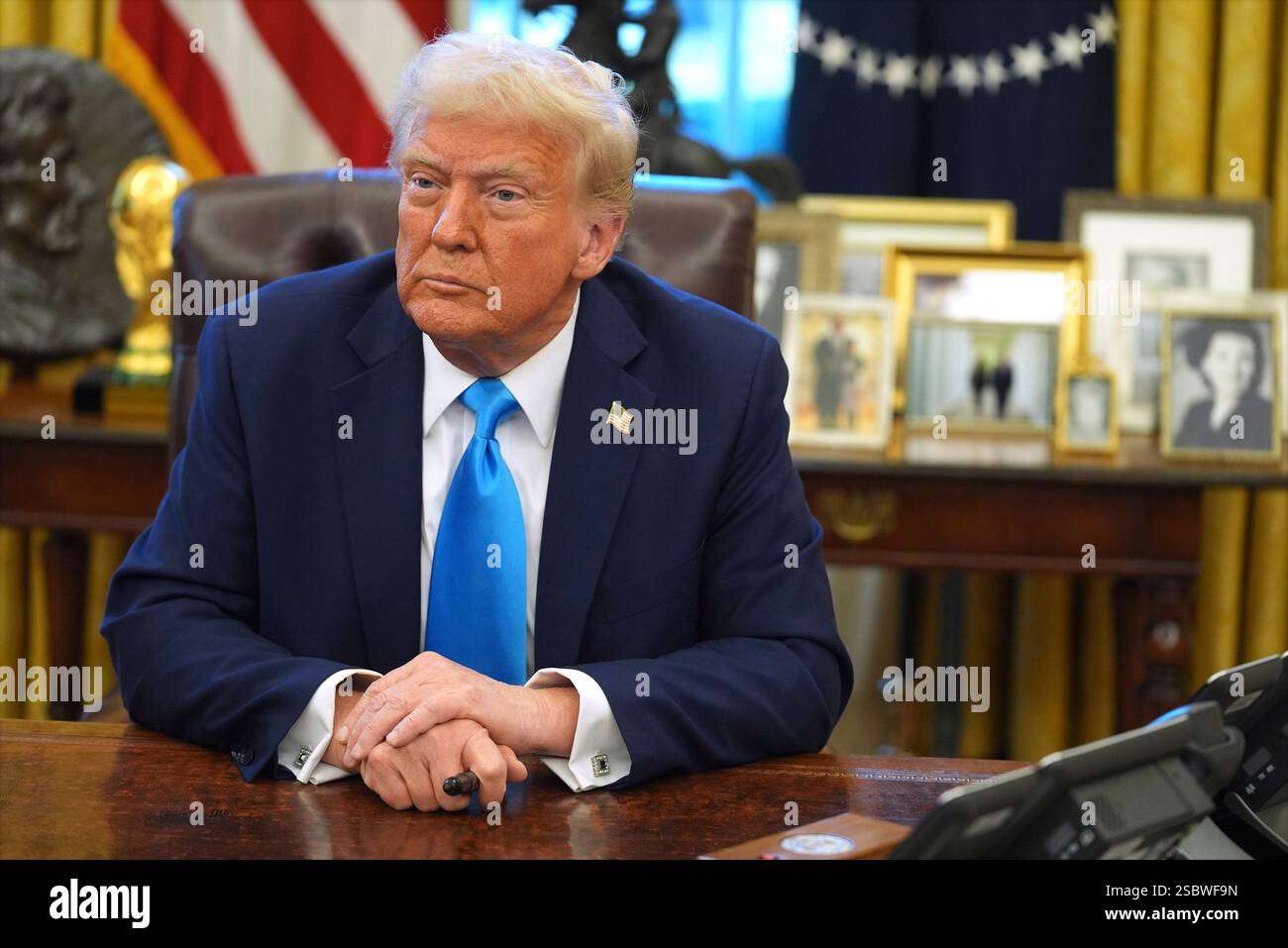 President Donald Trump speaks to reporters as he signs executive orders