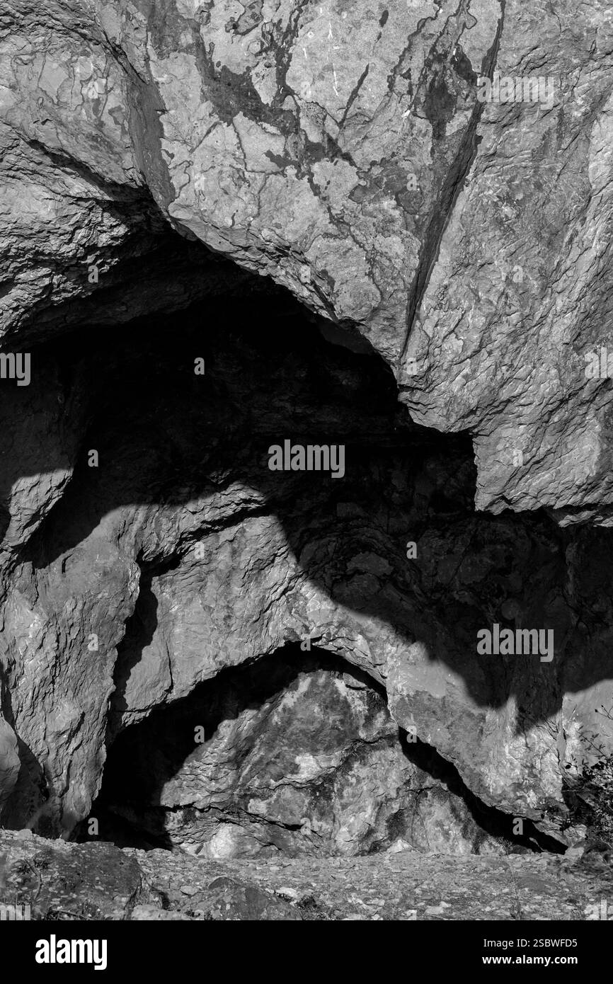 Gateway to the Unknown: Cave Entrance and Rock Formations Stock Photo