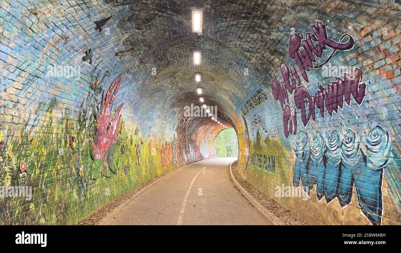Colinton Tunnel art installation. Graffiti designs in an old railway tunnel.  Edinburgh, Scotland. Old railway line track public right of way cycle pa - Smartphone Captured Stock Image