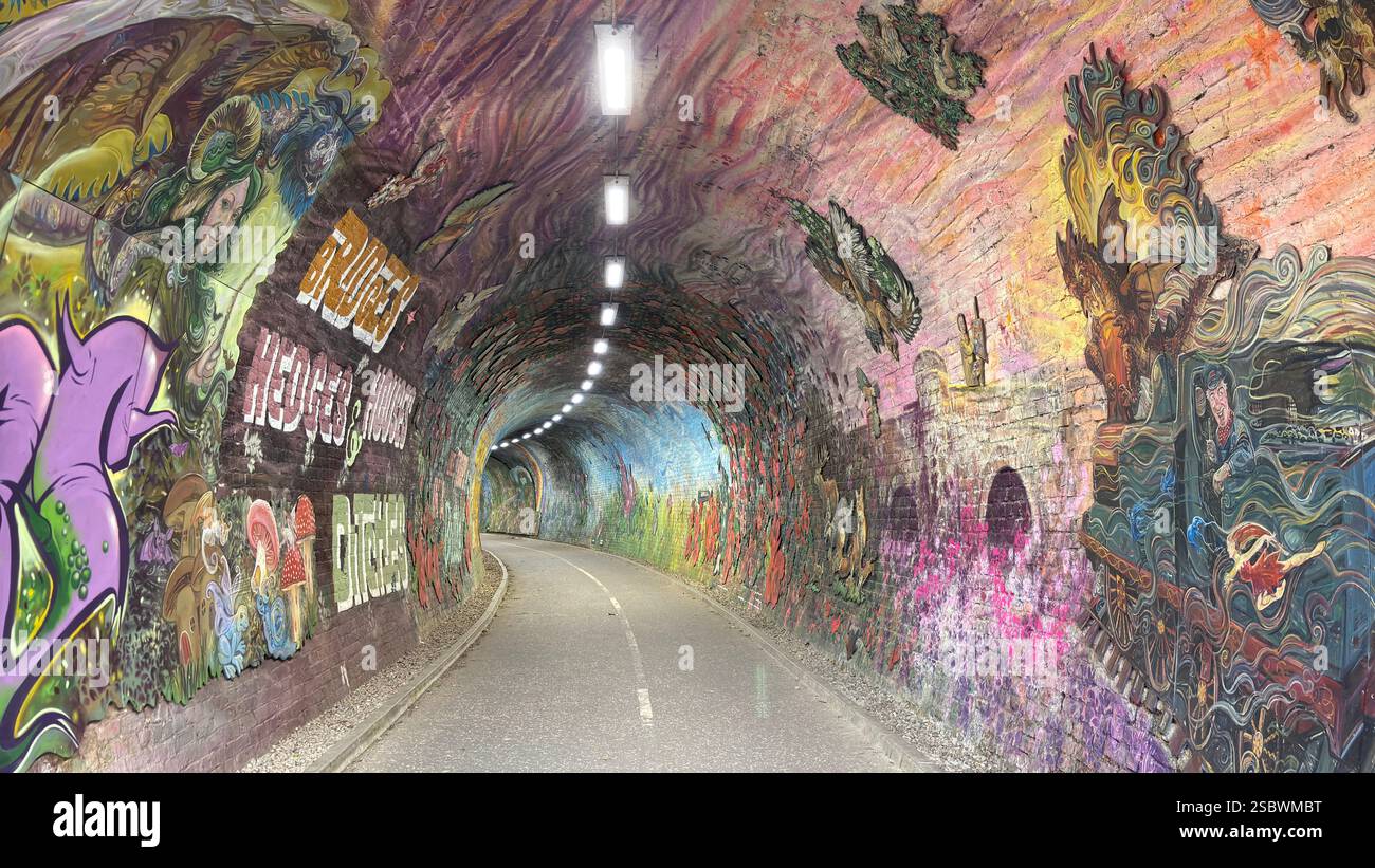 Colinton Tunnel art installation. Graffiti designs in an old railway tunnel.  Edinburgh, Scotland. Old railway line track public right of way cycle pa - Smartphone Captured Stock Image