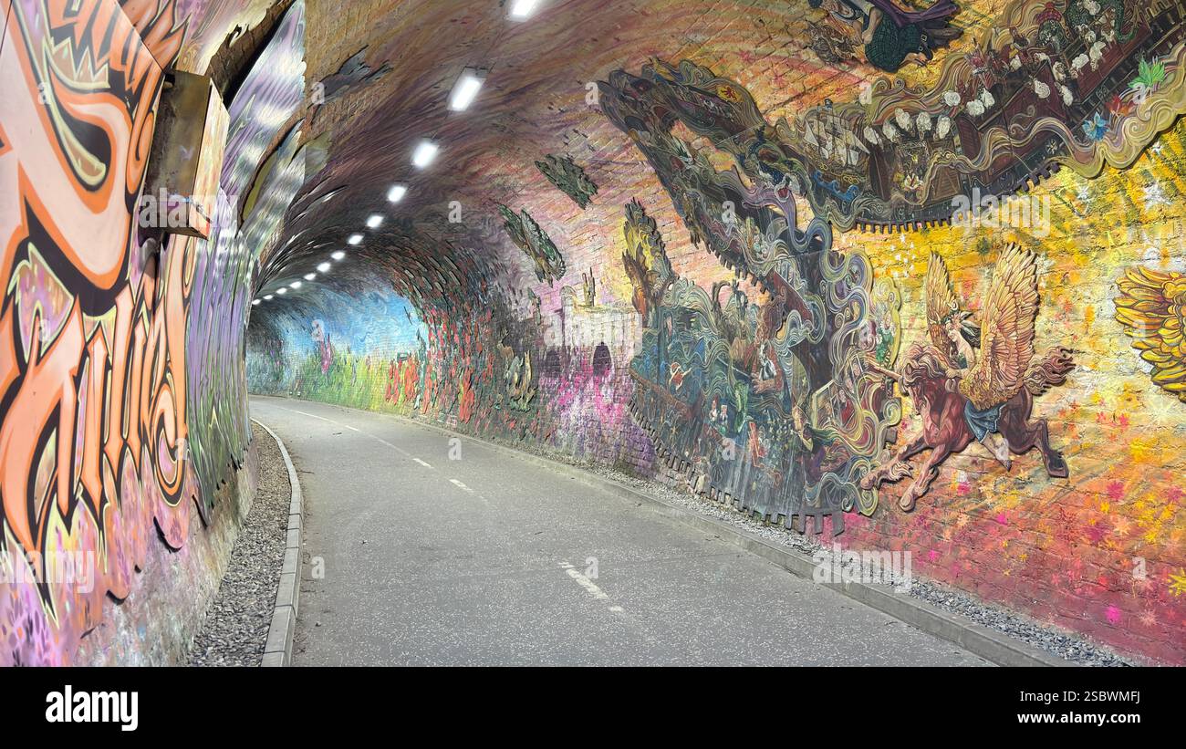 Colinton Tunnel art installation. Graffiti designs in an old railway tunnel.  Edinburgh, Scotland. Old railway line track public right of way cycle pa - Smartphone Captured Stock Image