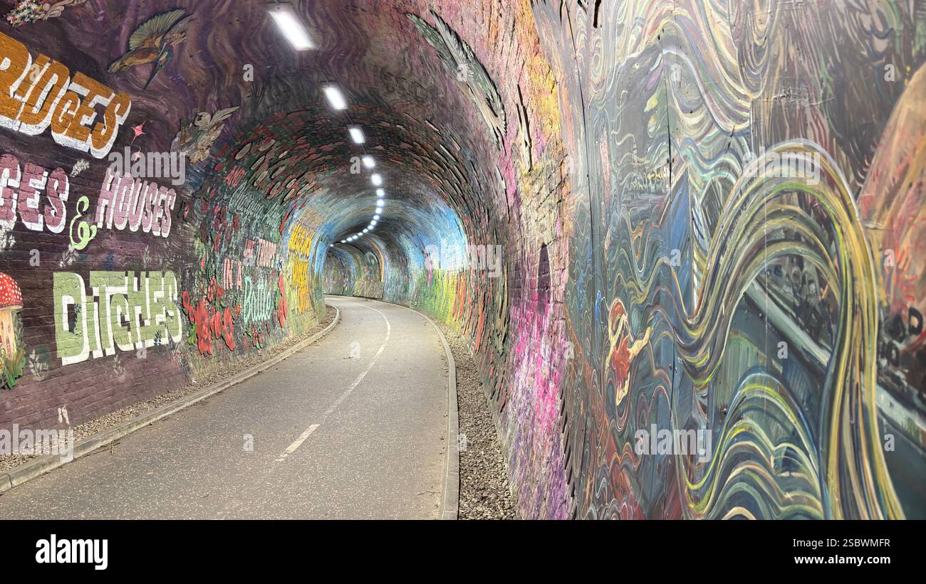 Colinton Tunnel art installation. Graffiti designs in an old railway tunnel.  Edinburgh, Scotland. Old railway line track public right of way cycle pa - Smartphone Captured Stock Image