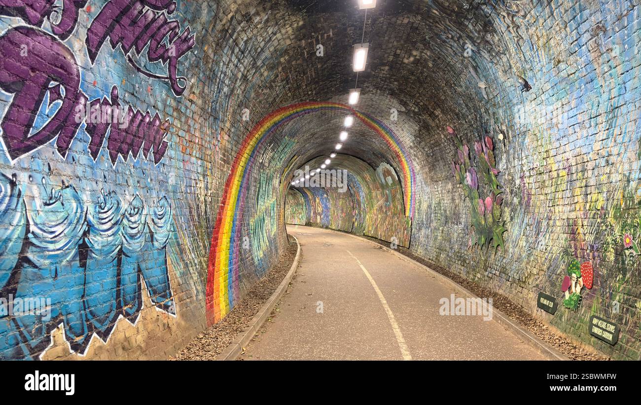Colinton Tunnel art installation. Graffiti designs in an old railway tunnel.  Edinburgh, Scotland. Old railway line track public right of way cycle pa - Smartphone Captured Stock Image