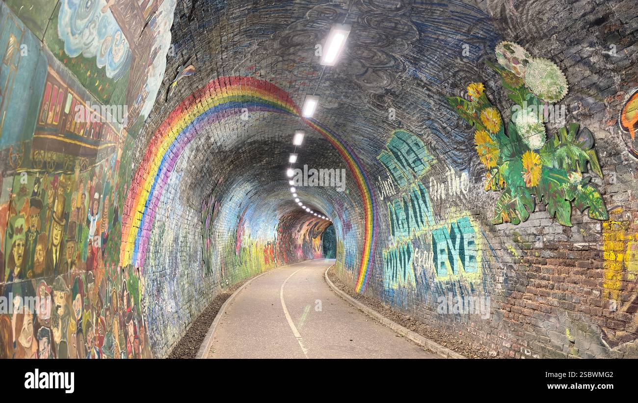 Colinton Tunnel art installation. Graffiti designs in an old railway tunnel.  Edinburgh, Scotland. Old railway line track public right of way cycle pa - Smartphone Captured Stock Image