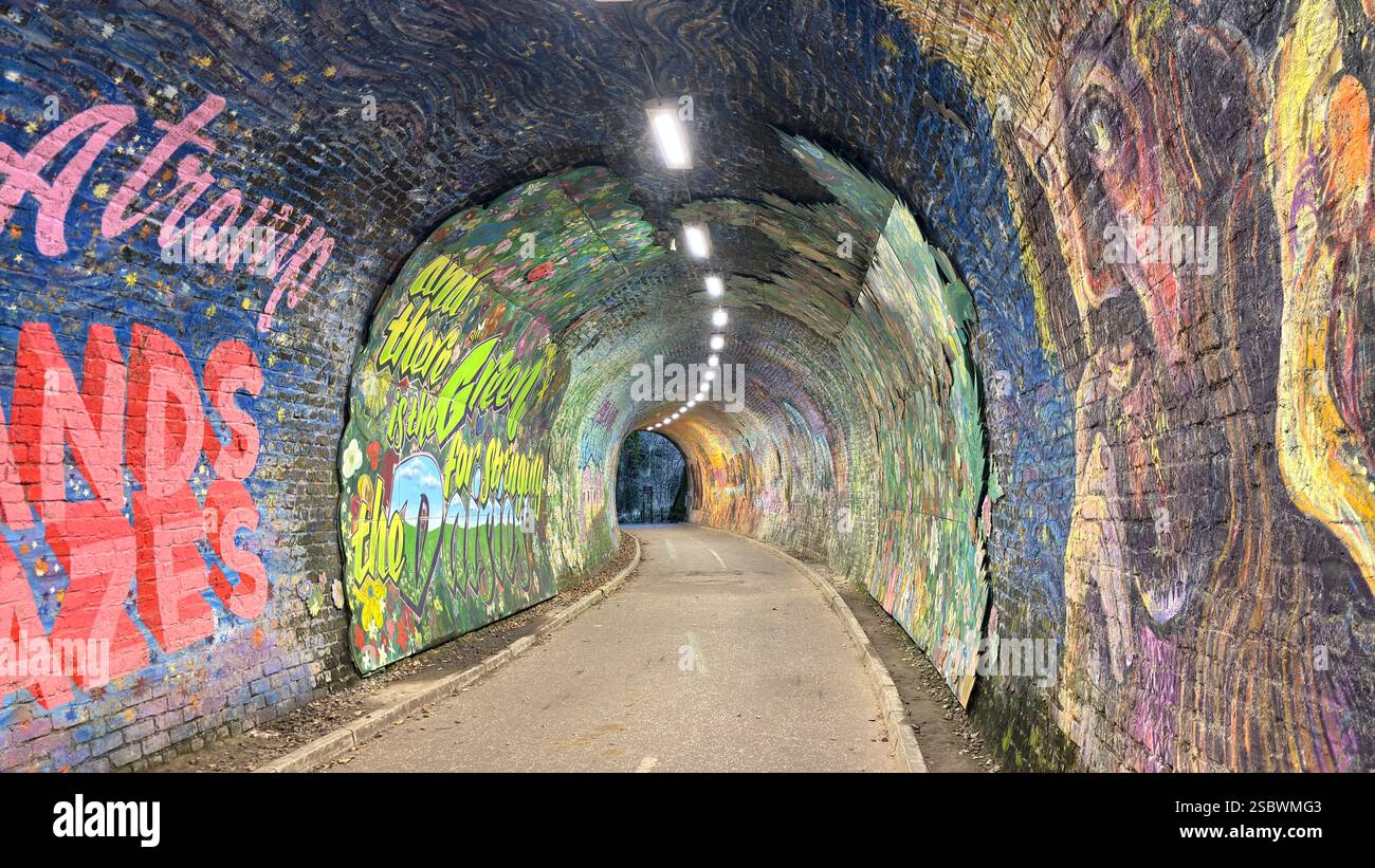 Colinton Tunnel art installation. Graffiti designs in an old railway tunnel.  Edinburgh, Scotland. Old railway line track public right of way cycle pa - Smartphone Captured Stock Image