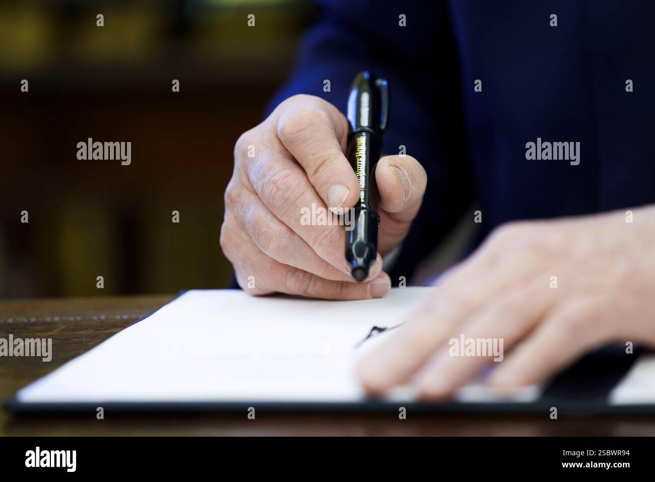 US President Donald J. Trump talks to reporters and signs a series of
