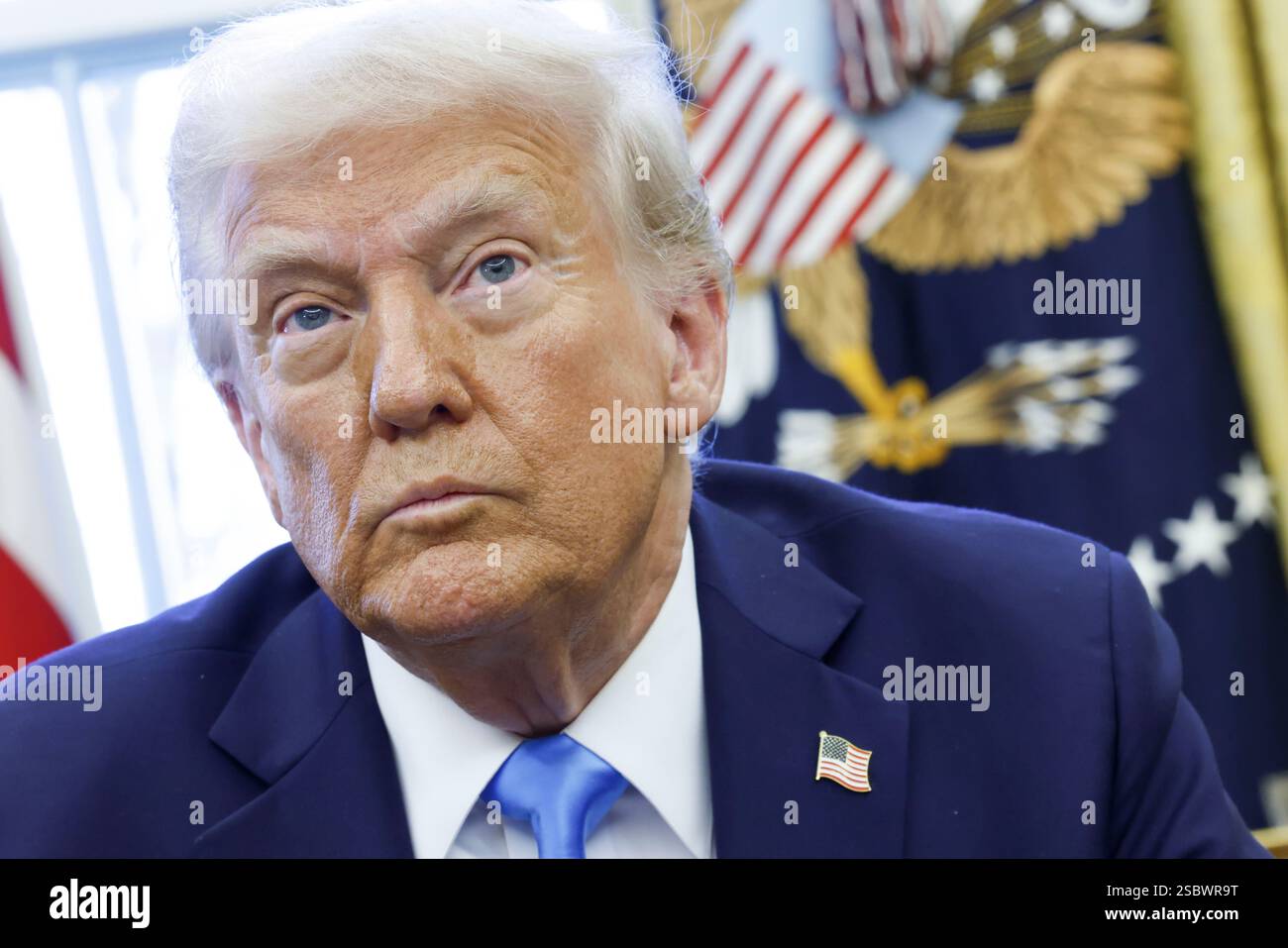 US President Donald J. Trump talks to reporters and signs a series of