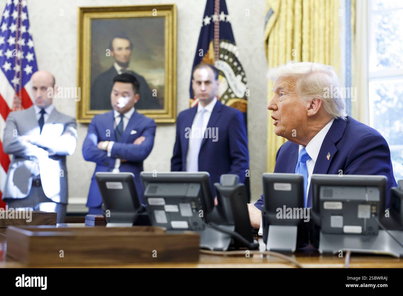US President Donald J. Trump talks to reporters and signs a series of