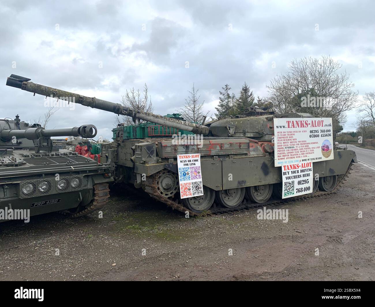 Tank Tanks Banbury Lane Northamptonshire army military war destroy painted green gun guns wars war battle track tracks outside metal armoured plate - Smartphone Captured Stock Image