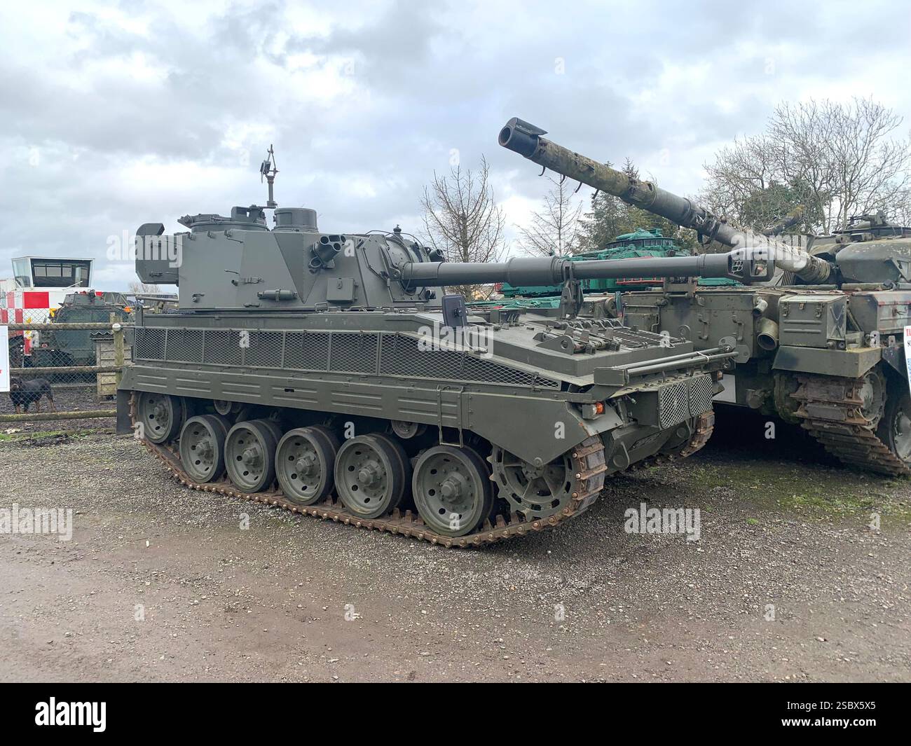 Tank Tanks Banbury Lane Northamptonshire army military war destroy painted green gun guns wars war battle track tracks outside metal armoured plate - Smartphone Captured Stock Image