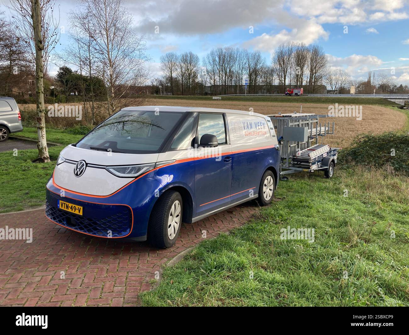 Volkswagen ID. Buzz electric vehicle with a trailer full of ladders - Smartphone Captured Stock Image