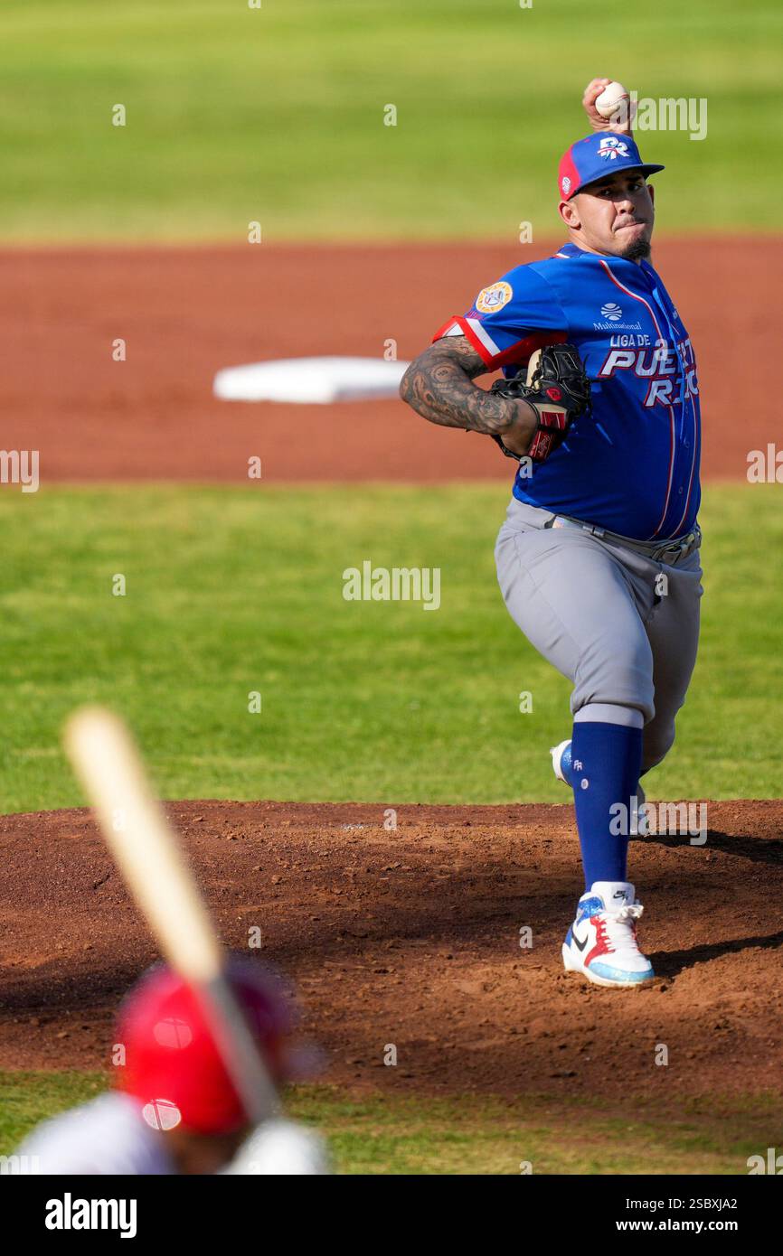 Puerto Rico's Eduardo Rivera pitches against Dominican Republic's