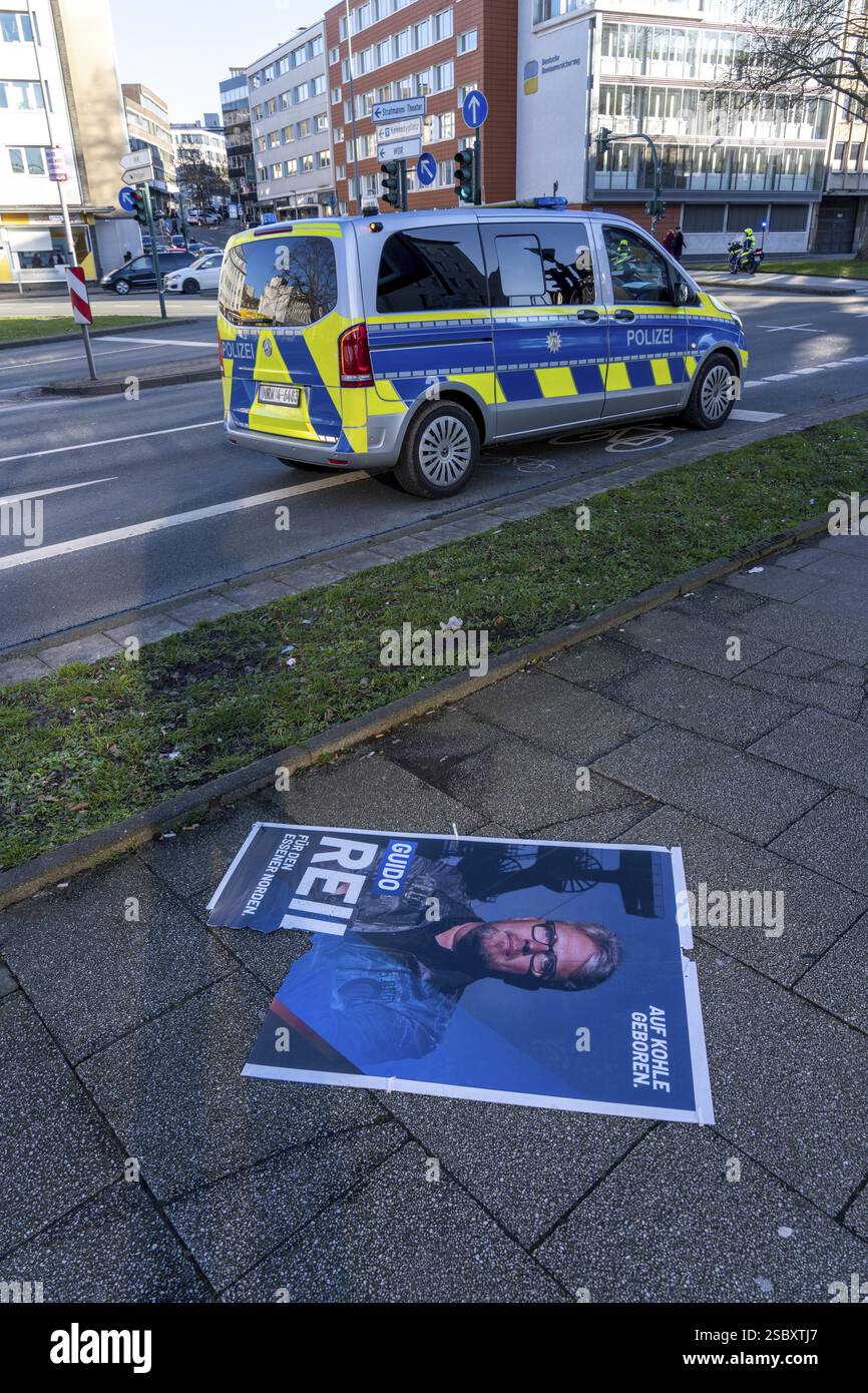Bundestag election campaign February 2025, torn down, destroyed election poster of the Essen AFD candidate Guido Reil, police vehicle, city centre of Stock Photo