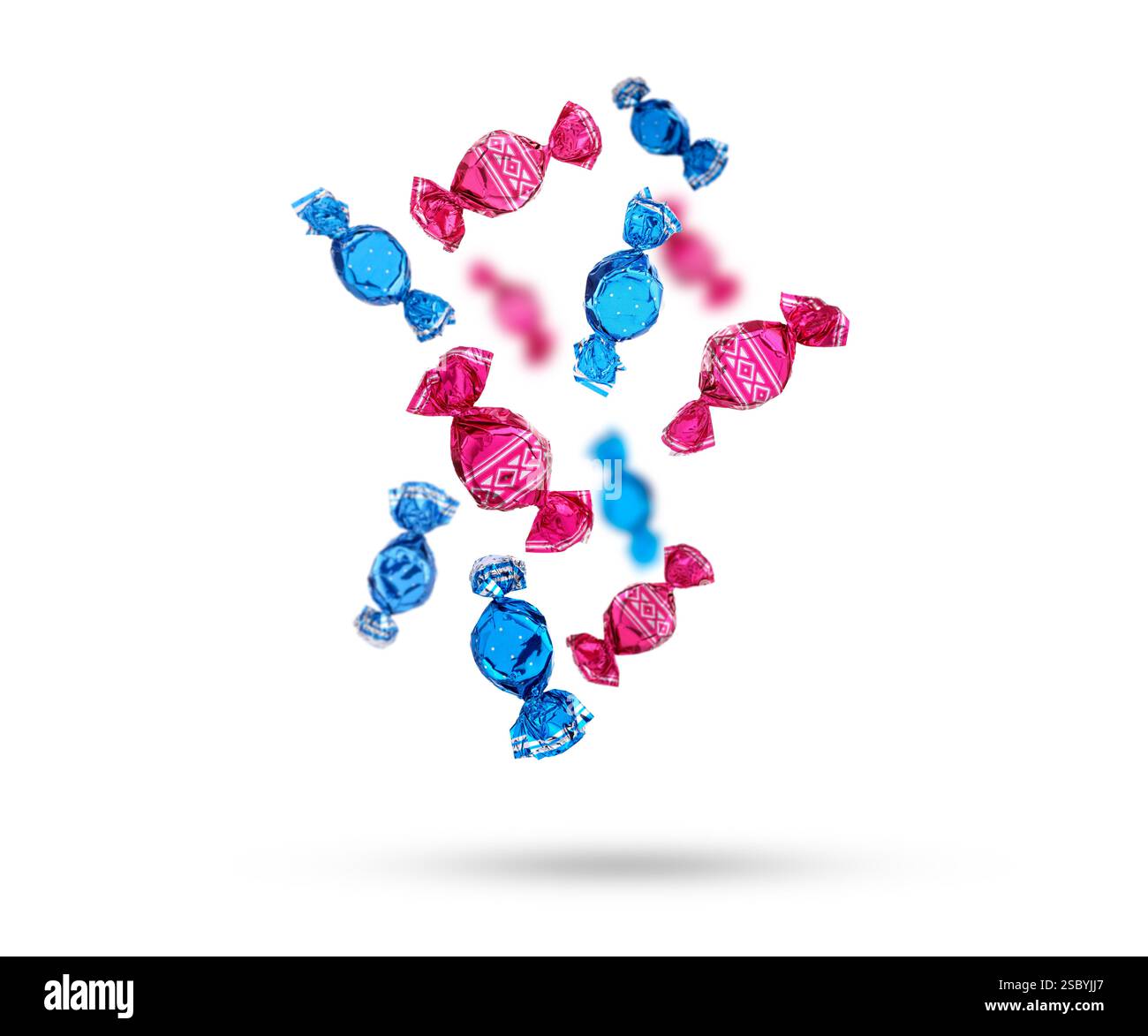 Candies in bright wrappers falling on white background Stock Photo
