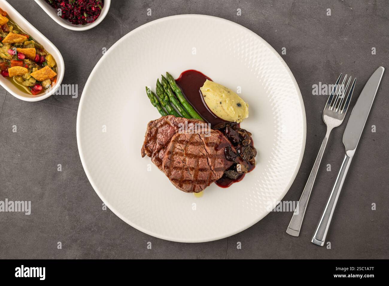 Grilled beef steak with red wine sauce, mashed potatoes, and asparagus ...