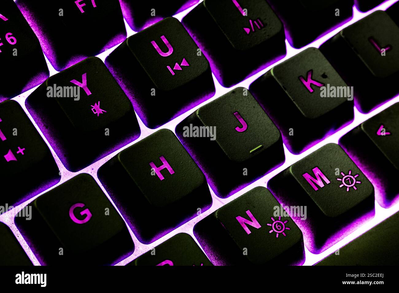 Black keyboard with purple light ambience Stock Photo