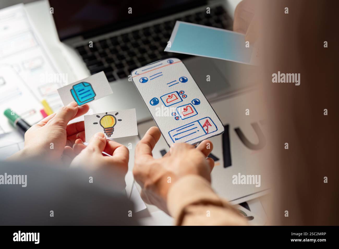 Creative team collaborating on UX UI design with wireframes and ideas. Stock Photo