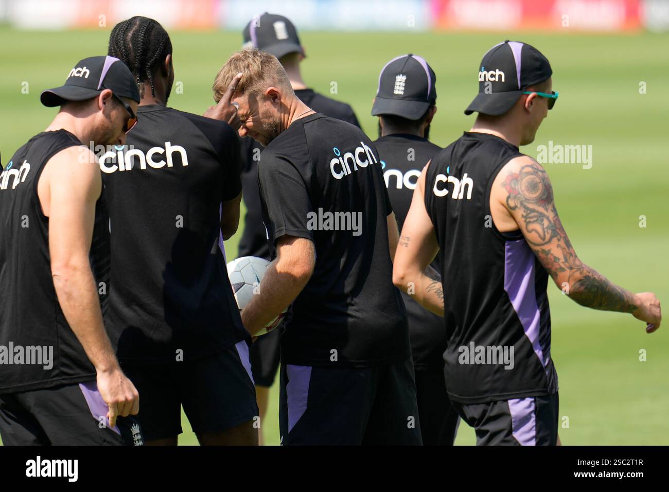 England's Joe Root, center, receives a forfeit from teammates during a ...