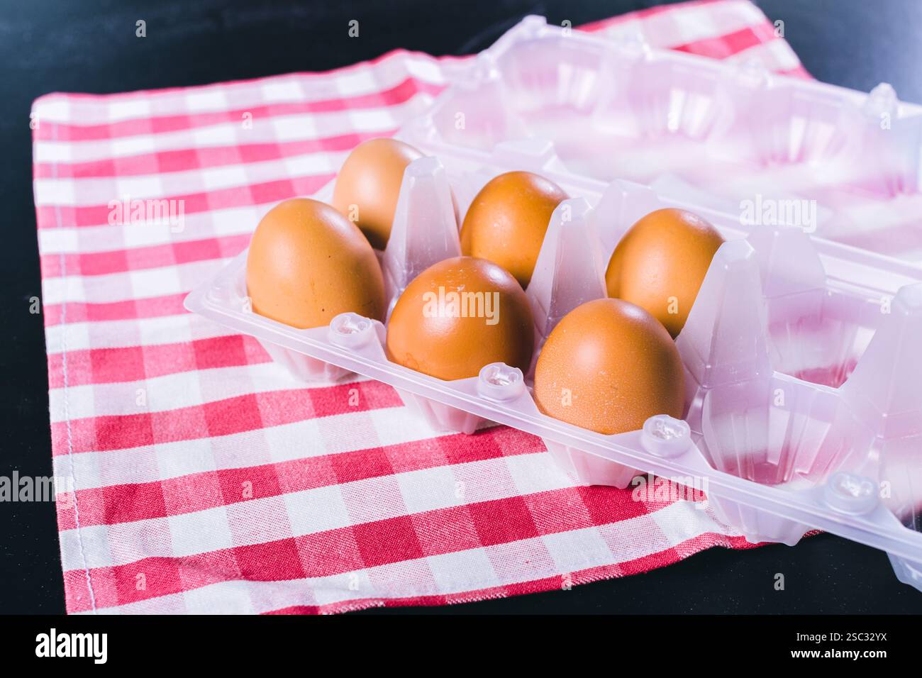 Eggs on tablecloth over black background Stock Photo