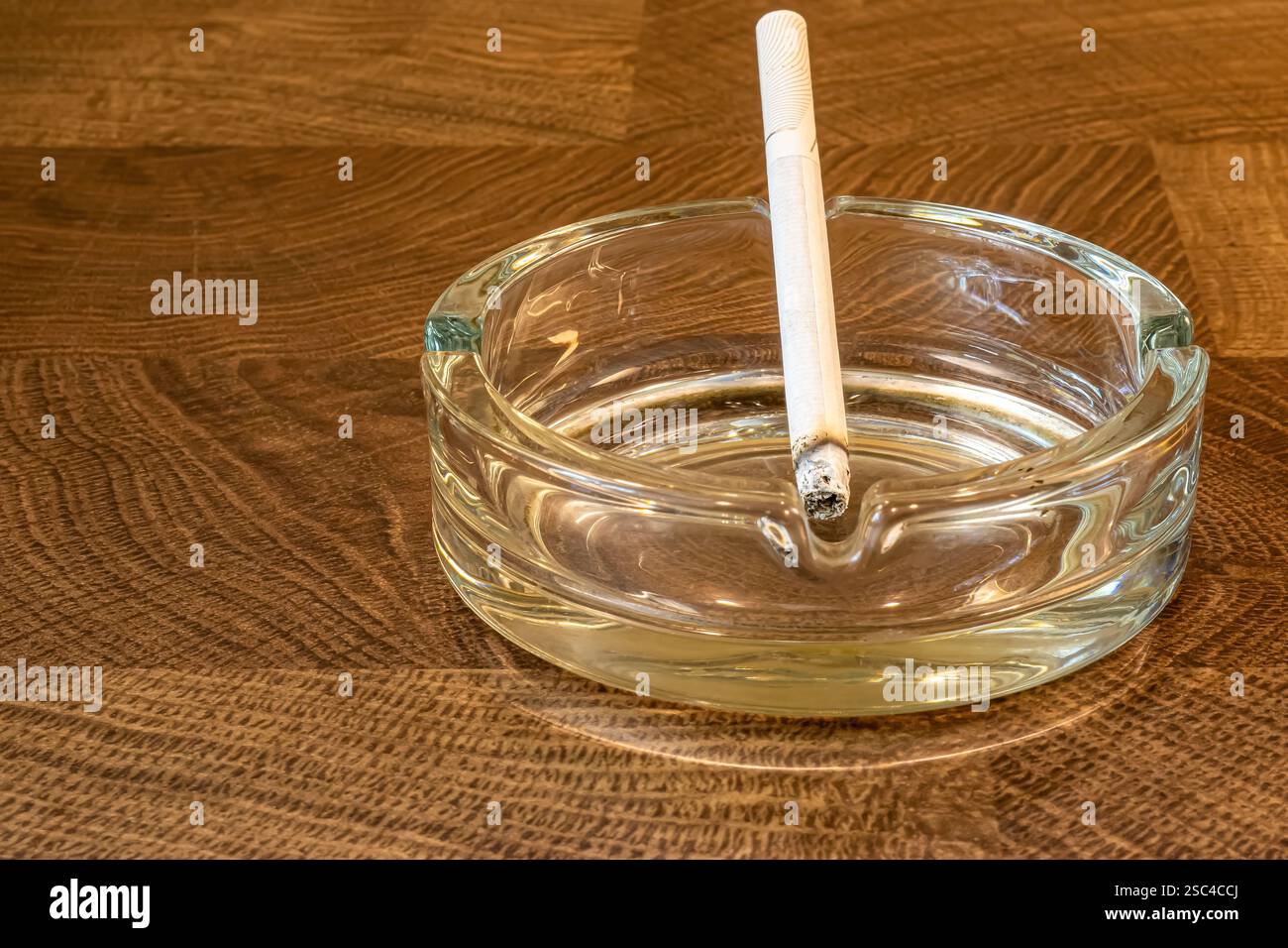 ashtray with cigarette in close-up Stock Photo