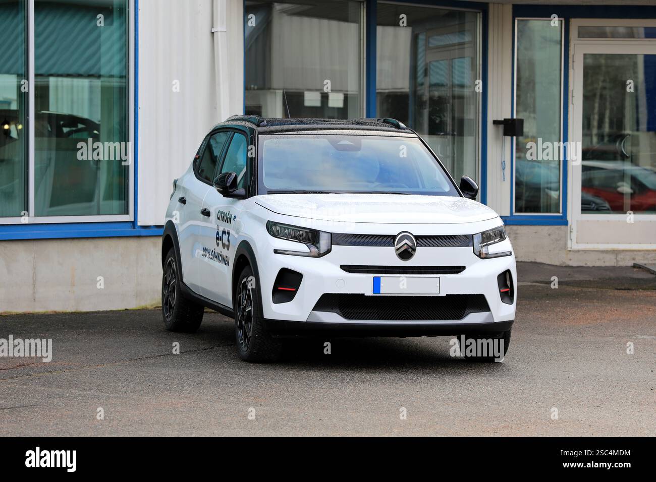 New, white Citroën ë-C3 battery electric car parked at the vehicle dealership. Front view. Salo, Finland. January 26, 2025. Stock Photo