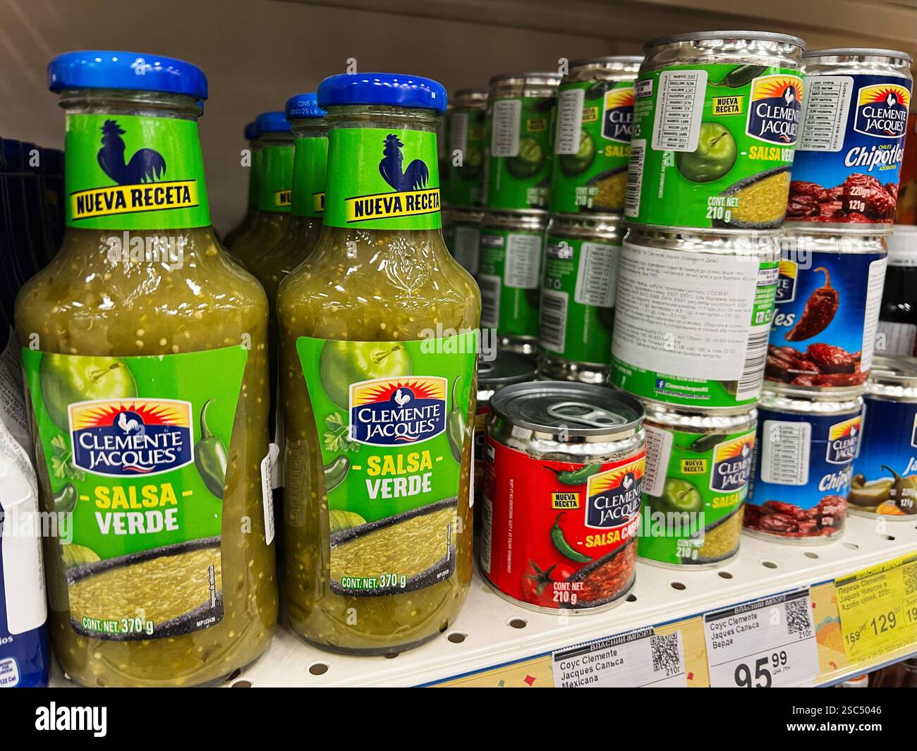 Kyiv, Ukraine - February 04, 2025: A supermarket shelf filled with jars and cans of traditional Mexican salsas. Stock Photo