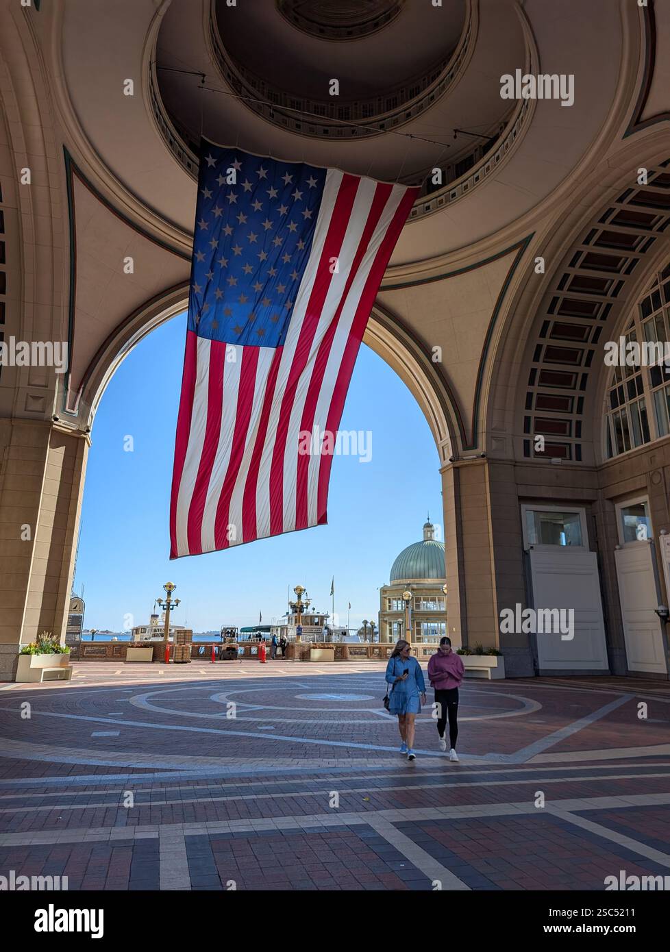 Large USA flag hanging in arch, Boston Harbor hotel, Rowes wharf, Boston, Massachusetts, USA - Smartphone Captured Stock Image