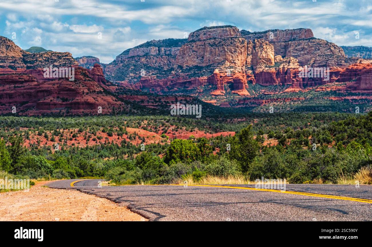 Scenic desert road leading to the stunning red rock formations of ...