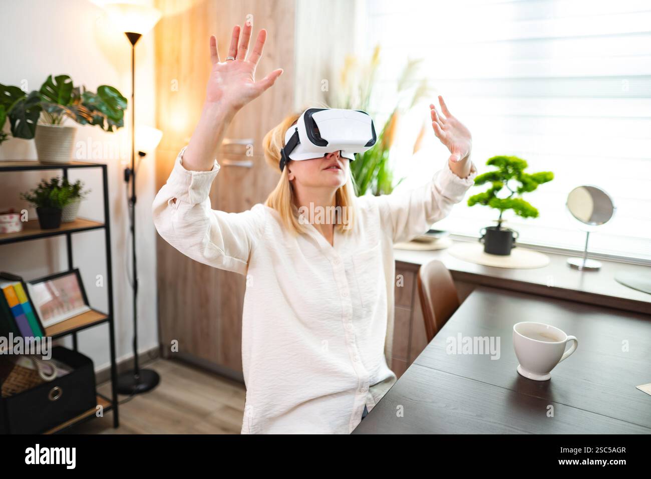 Exploring virtual realities in a cozy home environment with immersive technology Stock Photo