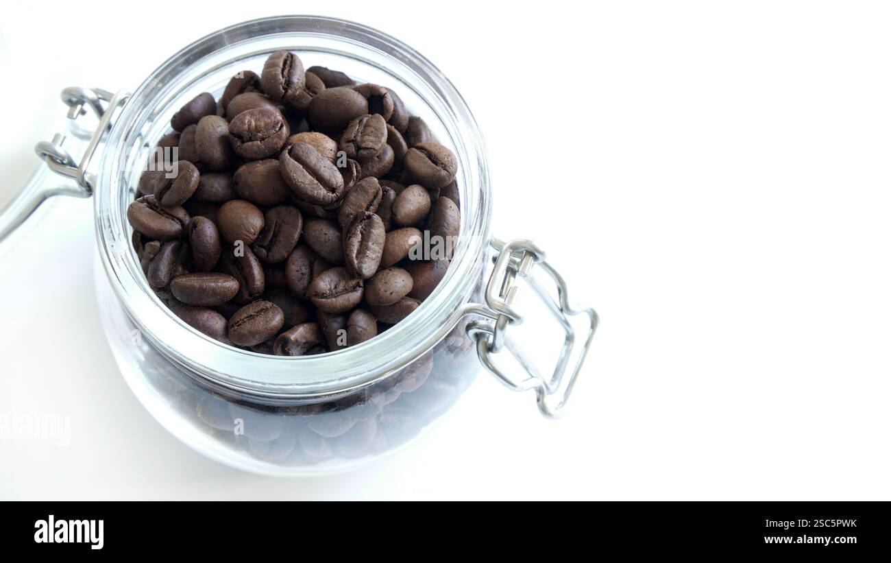Coffee beans in a glass jar isolated on a white background. Copy space. Directly above. Stock Photo