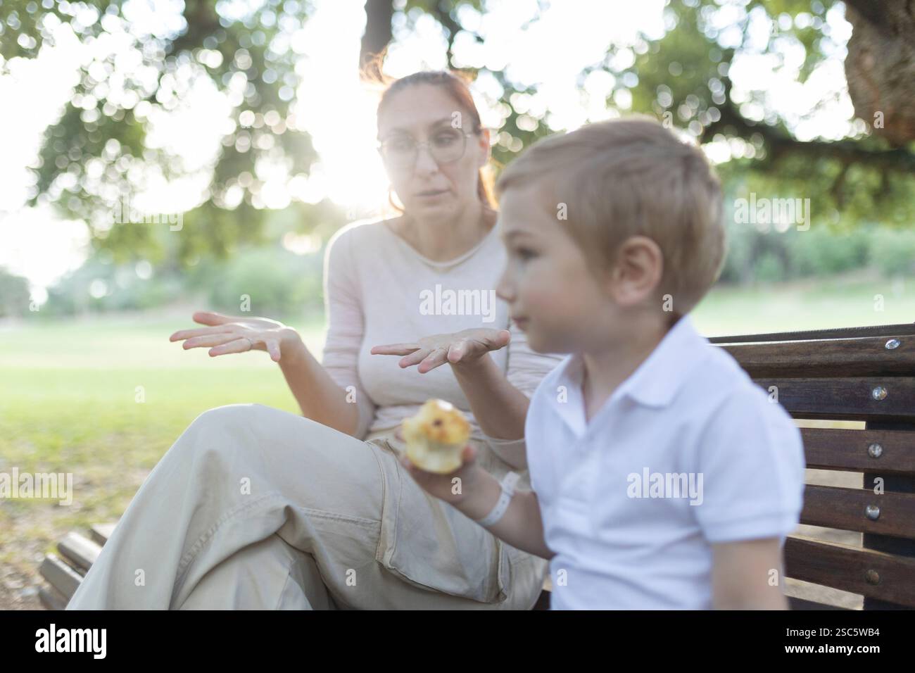 Mother explaining something important to her son while sitting on a ...