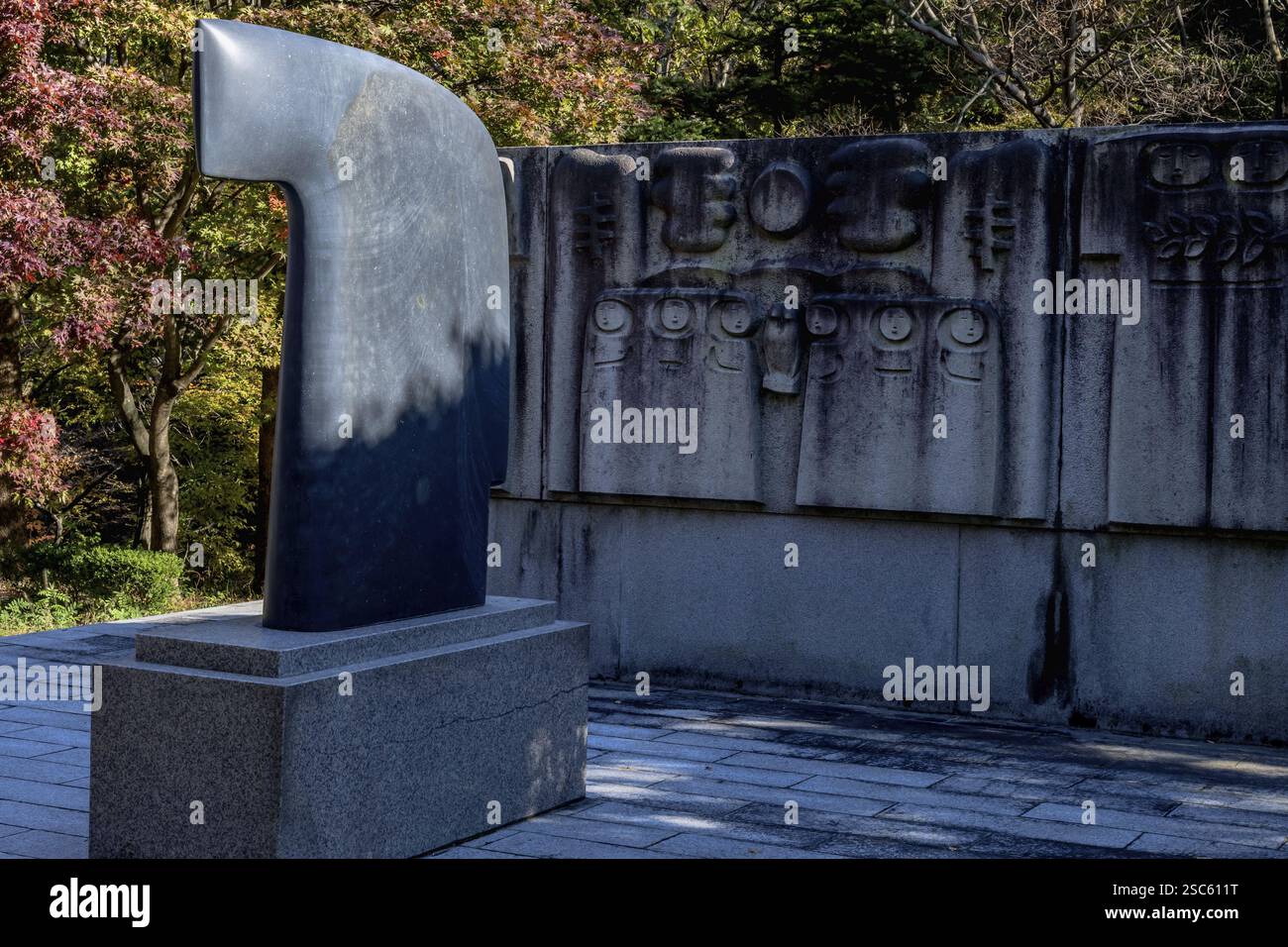 Gongju, South Korea, October 23, 2020: For editorial use only. Stone carved statue on plinth in mountainside woodland park. Artist unknown, Asia Stock Photo