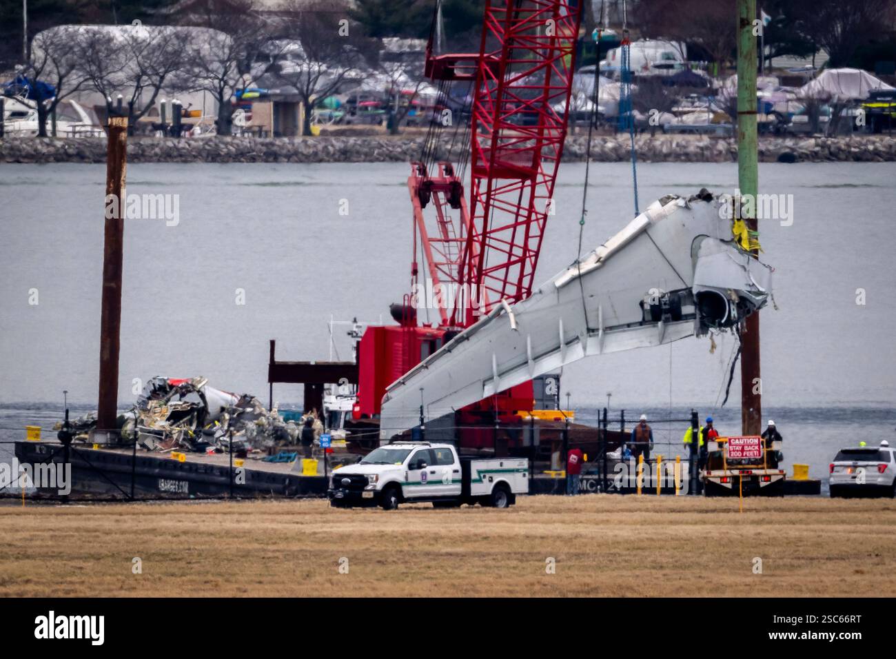 Salvage crews work near the wreckage site in the Potomac River of a mid ...
