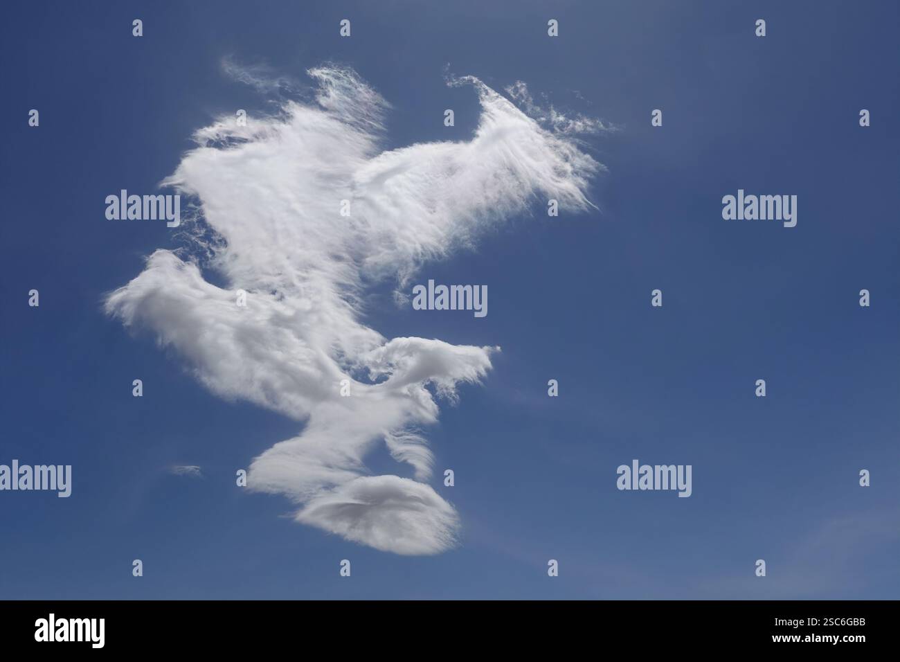 Single white cloud and blue sky on windy day. Stock Photo