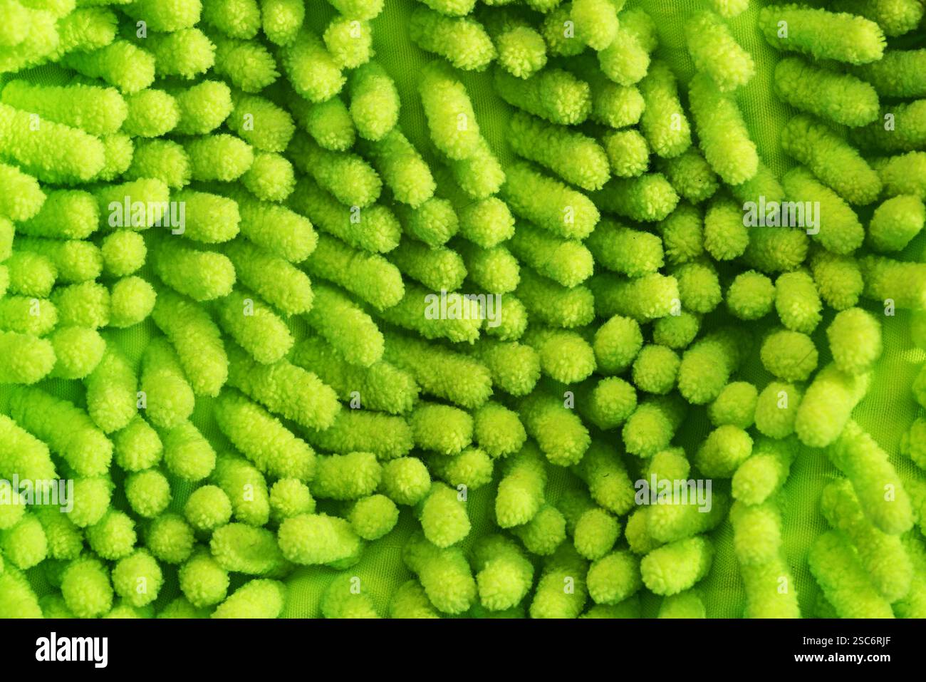 green microfiber cleaning mitt surface with fingers background texture Stock Photo